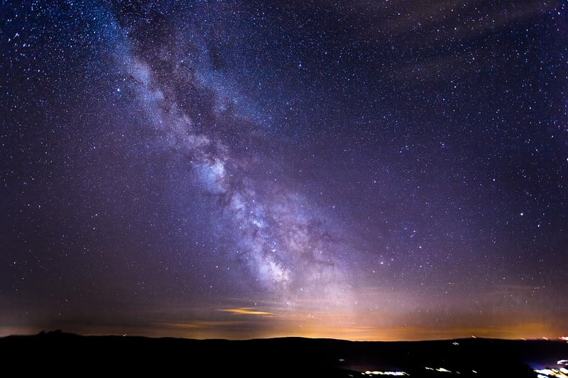Starry night sky over a serene lake